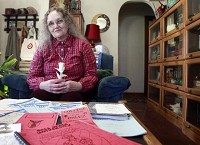 Patricia Ryan holds a flower made of toilet paper left on her desk by an inmate after one of her classes. / Jordan Kartholl/ The Star Press