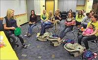 A big responsibility: Greenfield-Central senior Taylor Glover (left) opens another &ldquo;gift&rdquo; during a parenting class mock baby shower on Tuesday. The class focuses on what it&rsquo;s like to be a parent by using lifelike baby dolls that students must care for around the clock. Staff photo by Tom Russo