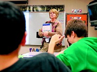 Lisa Barkdull goes over a lesson with her sixth-grade students at Maple Ridge Elementary School. Barkdull is a resource teacher dealing with students who have special needs. Staff photo by John P. Cleary