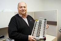 Nick Deeter, founder and chairman of the board at OrthoPediatrics, holds up a box of blade implants Friday in Warsaw. Deeter said the company has had to adjust its operation to account for a new medical-device tax that takes effect Jan. 1. Staff photo by Santiago Flores