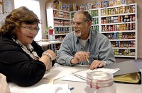 Charlie Gregson, 63, of Cedar Lake, (right) smiles as he talks with director Stacey Previs about algebra at the Lowell Adult Learning Center in Lowell, Ind. Thursday February 14, 2013. | Stephanie Dowell~Sun-Times Media