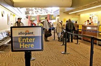 Passengers check in for a Allegiant Airlines flight at the Gary/Chicago International Airport Sunday, February 17, 2013, in Gary, Ind. Allegiant Air has been flying out of the Gary Airport for over year and aided the airport in surpassing the 10,000 passenger mark in December 2012. | Scott M. Bort~For Sun-Times Media