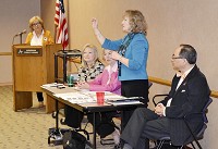 The League of Women Voters of Anderson hosted a panel of educators and lawmakers who discussed current education topics Saturday morning at the Anderson Public Library. Board Member Joyce Moore (far left) watches as State Representatives Terri Austin and Sue Ellington (seated) and Anderson Community Schools Superintendent Felix Chow, right, listen to Indiana Superintendent Glenda Ritz, who spoke to more than 100 in attendance. Photo by Heath Hensley