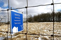 WANTED: A wind farm sign located along U.S. 31 in Tipton County shows the divide. Staff photo by Tim Bath