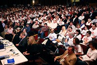 CROWD: The Tipton High School auditorium was full of proponents and opponents of the Prairie Breeze Wind Farm, during the public hearing on Wednesday. Opponents wore white shirts. Staff photo by Kelly Lafferty
