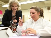 Indiana Superintendent of Public Instruction Glenda Ritz, left, watches dental assistant student Sami Pardinek, of Whiting, during a class Wednesday at the Area Career Center in Hammond. Staff photo by John J. Watkins