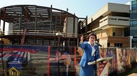 Dr. Linda Bennett, president of the University of Southern Indiana, addresses the crowd before the final beam was put in place during the topping off ceremony for USI&rsquo;s $17.2 million Teaching Theatre on Thursday. Staff photo by Kevin Swank