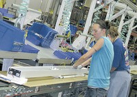 Production-line workers at Group Dekko near Garrett assemble lighting fixtures. Staff photo by Sue Carpenter