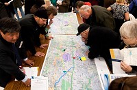 Visitors view maps documenting a route for the Illiana Expressway a year ago during a public meeting at Crown Point High School.&nbsp;A public comment period on the Illiana Expressway will open Oct. 14.
