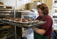 Lisa Delaney of Stone House Restaurant bakes Friday at her business in Delphi. 'It has brought us so much business,' DeLaney said of the new Indiana 25, which opened last year. 'I am looking forward to this next section opening because there is no place to stop and get out of the car between here and Logansport or Peru.' / Michael Heinz/Journal &amp; Courier