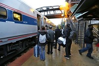 Passengers line up to board Amtrak's Hoosier State train Wednesday, November 6, 2013, at the Amtrak platform in Riehle Plaza. The train runs from Indianapolis to Chicago with stops in Crawfordsville, Lafayette, Rensselaer and Dyer. Staff photo by John Terhune