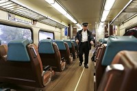 Conductor John Cudney walks through the cars of the South Shore line train Wednesday, November 6, 2013, as it travels through Gary, Indiana. / John Terhune/Journal &amp; Courier