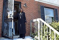 Silvia Willis checks out the home she and her husband Milton bought for $1 as part of Gary's Dollar Home Program on Tuesday. Staff photo by John J. Watkins
