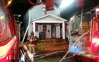 FILE- In this December 21, 2013 photo, firefighters respond Friday to a fire at 626 E. Maryland St. The house has been vacant for more than one year and the location of the owner, Krystle Cupp, is unknown.