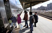 Passengers board a South Shore train bound for Chicago Wednesday morning. Staff photo by John Luke
