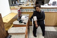 Alexandria Brown of Merrillville gets her blood pressure checked last April during a health screening at the Merrillville Beauty College in Merrillville. The screenings were part of the Indiana Black Barbershop Health Initiative. Regular screenings and care could improve Indiana's health rankings. Staff photo by Jonathan Miano