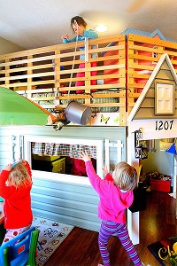 Kelsey Weber drops a bucket with a dinosaur in it to her sister Maggie Weber at My Caterpillar Clubhouse, an in-home daycare operated by Stephanie McKinstry. KT photo | Tim Bath
