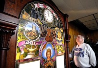 THB photo/John P. Cleary Dick Dunn, Anderson Elks Lodge 209 secretary, looks over the 1903 leaded glass-covered clock and chimes that were used in the lodge's 11 o'clock toast ceremony as he prepares the lodge for a March 22 liquidation sale of all its items. After 121 years the Anderson lodge has folded.