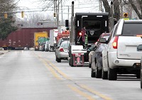 Traffic backs up down Madison Street in this file photo as a train crosses the road. The future of transportation through Goshen hinges upon a proposed overpass over multiple sets of tracks. &nbsp;Staff photo by Sam Householder