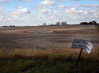 A vandalized sign stands in 2010 on an empty stretch of land where homes were razed to make way for the proposed Peotone airport. Ground could be broken on a south suburban airport at Peotone as early as 2016. Times of Northwest Indiana file photo