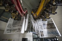Newspapers for the South Bend Tribune and Elkhart Truth hang still from the South Bend Tribune printing plant after a power outage blacked out downtown and halted newspaper production Friday. SBT Photo by Robert Franklin