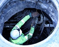 An Indiana Michigan Power Company employee pulls new wire in a manhole about 5:30 p.m. Friday at Lafayette Boulevard and Washington Street in South Bend in the ongoing effort to restore power to downtown South Bend after Friday night's electrical fire under ground that has left 800 customers&nbsp;without power. SBT Photo/GREG SWIERCZ