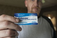 Joe Smith, a recovering heroin addict who lives in Goshen, displays an 8-milligram dose of Suboxone, a partial heroin antidote that helps opiate users overcome withdrawal symptoms and cravings, at his home Wednesday. SBT Photo/SANTIAGO FLORES