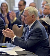 Good work: Gov. Mike Pence applauds during the Regional Cities Initiative meeting in Indianapolis on Tuesday. He praised the growth of cooperation among neighboring cities and counties throughout the state.Tribune-Star/Jim Avelis