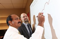 Professor of Finance Bala Arshanapalli and Assistant Professor of Economic Micah Pollak work on their Northwest Indiana Coincident Index at Indiana University Northwest.