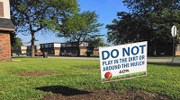 Signs put up by the EPA warn residents in the West Calumet Housing Development not to play in the dirt or mulch. Joe Puchek / Post-Tribune