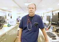 Steve Pahner, emergency medical physician at Floyd Memorial Hospital, stands in the ER. He said his staff has dealt with heroin-related issues for several years, but the numer of overdose patients has increased sharply in the last week or so. Staff photo by Jerod Clapp