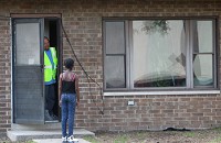 Makyla Nelson, 10, looks for a neighbor to play with but instead is turned away by an EPA contractor cleaning her friend's apartment at the West Calumet Housing Complex in East Chicago. It's been at least 20 years since environmental regulators knew the complex was built in the footprint of a long-demolished lead smelter, but residents only recently learned exactly what was in their soil and what a cleanup means for them. Staff photo by Jonathan Miano 