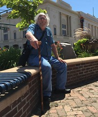 Richard Wolf, an advocate for the disabled, has filed suit aagainst the city of Elkhart banning him from the city Facebook page. He's picture here on July 31, 2015, with the Lerner Theatre in the background. He has pushed form more handicapped-accessible parking around the theater. Staff photo by Tim Vandenack