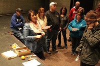Kirsten Calhoun (center), a New Palestine resident who works with the Overdose Lifeline, passes out free Narcan doses to attendees interested in carrying the medication. Caitlin VanOverberghe | Daily Reporter