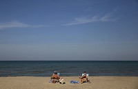 Dave Branneman and his wife, Doris Branneman, of Mitchell, read on the beach Tuesday, Nov. 1, 2016, at Indiana Dunes National Lakeshore in Chesterton. Staff photo by Jonathan Miano