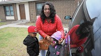 


Shantel Allen gets daughter Samira and son Charles ready for a drive this month from their home in the West Calumet Housing Complex in East Chicago. Samira, 2, was recently found to have lead levels in her blood more that five times what the federal government says warrants intervention.(Antonio Perez / Chicago Tribune)


