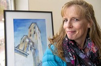 Artist Cathleen Huffman in one of her watercolors of an Indiana grain elevator. Staff photo by Tom Russo