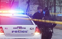 Police wait for a search warrant to enter a home to investigate a triple homicide in February 2016. Staff photo by Cathie Rowand