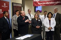 Pat Bankston, third from left, associate dean of the medical school at Indiana University Northwest in Gary, announces the signing of a letter of intent to form a medical residency consortium among nine local health care institutions. Staff photo by Damian Rico