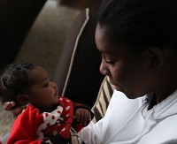 Healthier Moms and Babies client Nasira Martin of Fort Wayne shares a moment with her 6-week-old daughter, Azariah Dominguez, in December 2016. Martin lives in 46806 zip code, which had the fourth-highest rate of Indiana babies dying before their first birthdays between 2010 and 2014. Staff photo by Damian Rico