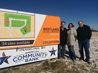 Mihai Raicu, left, Mihaela Raicu and Mark Reynolds at the 15 ares in Munster's West Lakes Estates they are developing. The land borders the corridor that will include the South Shore's West Lake extension if built according to current plans. Staff photo by Andrew Steele