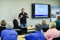 Matthew La Rocco, a needle exchange counselor at the Louisville Metro Department of Health, talks with members of the business community about the affects of drug and alcohol users on employees during a One Southern Indiana series in New Albany on Tuesday. Staff photo by Tyler Stewart