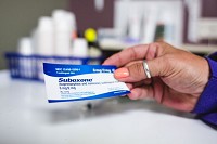 A lead nurse at Turning Point Center in Jeffersonville holds up a sublingual Suboxone strip. Staff photo by Josh Hicks