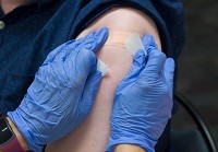 A bandage is placed over a patient's arm after receiving a Hepatitis A vaccine during a clinic at the Wayne County Health Department on Thursday, July 19, 2018. Staff photo by Mickey Shuey
