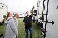 Douglas and Julie Luckey of Cadillac, Mich., look for a tow-able with the help of sales associate Brett Yoder, right. Sales remain at strong at Total Value RV in Elkhart despite concerns about tariffs and other economic issues. Staff photo by Santiago Flores