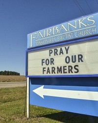 A simple request: The Fairbanks Missionary Baptist Church has used its sign along Indiana 63 to implore members of its community to pray for farmers in the area. Staff photo by Austen Leake