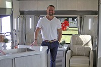 Dustin Johns, owner of Innovation Inc. LLC and Travel Lite RV, stands inside the company's new Evoke travel trailer. The company has entered the full-size travel trailer market with units produced in the new Travel Lite factory in Syracuse. Staff photo by Roger Schneider