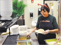  Karen Johns serves tacos during lunch at Highland Middle School on Friday. Staff photo by  Don Knight