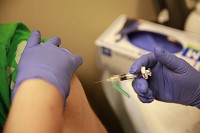 A nurse administers the hepatitis A vaccine to a patient Tuesday at the Monroe County Public Health Clinic in Bloomington. Staff photo by Jeremy Hogan