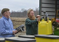 GETTING READY: Jack (left) and Mike Strain (right) work on a planter on the family farm in southwest Vigo County on Friday afternoon. Staff photo by Austen Leake